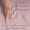 A close-up of a hand resting on a pink fabric, with icons and text describing the fabric's properties. Produktbild-Vorschau