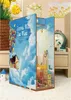 A 3D diorama-style book nook kit depicting a cityscape and a house floating among clouds, with balloons. The product is placed on a surface next to other decorative items. Náhľad obrázku produktu