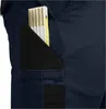 A close-up view of a navy blue work pant pocket with a folding ruler inserted. Produktbild-Vorschau