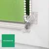 Close-up of a green roller blind mechanism with a chain and a chain holder. Produktbild-Vorschau