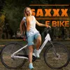 A young woman is posing with an electric bike in a park. Produktbild-Vorschau