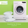 Three white pillows are stacked in front of a washing machine against a bright green wall. Náhled obrázku produktu