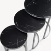 A set of three nesting tables with black marble-effect tops and silver metal legs, shown from a top-down diagonal angle against a white background. Anteprima dell’immagine prodotto
