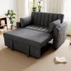 A gray sofa bed is shown in a living room setting with a bookshelf and a plant in the background. Podgląd zdjęcia produktu
