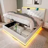 A modern white bed with storage, illuminated by LED lights, is shown in a bedroom setting. Anteprima dell’immagine prodotto
