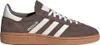 A side view of a brown Adidas Handball Spezial shoe with white stripes and laces, on a white background. Voir les images du produit