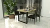 A dining table with chairs set up in a modern dining room. Produktbild-Vorschau