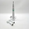 A white electric toothbrush with a charging base and two replacement brush heads on a white background. Produktbild-Vorschau
