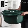 A person is holding a green plastic basin, with dimensions and weight indicated by text overlays. Podgląd zdjęcia produktu