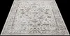 A vintage-style rug with a cream and brown pattern is shown from a diagonal angle against a black background. Produktbild-Vorschau