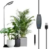 A plant grow light with a stand and several potted plants. Produktbild-Vorschau