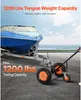 A boat on a trailer is being moved by a trailer mover. The scene is set by the sea. Produktbild-Vorschau