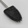 A close-up view of a black silicone toilet brush with a silver handle, set against a white background. Produktbild-Vorschau