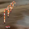 Candy canes lit up and placed in the snow. Produktbild-Vorschau