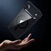 A hand is holding a phone case with a phone inside, against a dark background. Produktbild-Vorschau