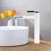 A modern bathroom sink with a white faucet and flowers. Produktbild-Vorschau