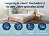 A bedroom scene with a mattress on a wooden bed frame, accompanied by marketing icons and text. Produktbild-Vorschau