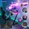 A gaming setup with a desk, chair, computer, and accessories, illuminated by LED lights. Produktbild-Vorschau