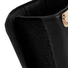 A close-up view of the black and gold Lionelo Thermup Go Evo bottle warmer, focusing on the velcro closure and a gold metal accent. Produktbild-Vorschau