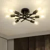 A black, multi-arm ceiling light fixture with exposed bulbs is shown against a white ceiling. Náhled obrázku produktu