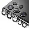 A close-up view of multiple camera lens protectors arranged on a surface, with a portion of a smartphone visible in the background. Produktbild-Vorschau