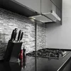 A modern kitchen counter with a gas stovetop, knife block, and spice grinders. Podgląd zdjęcia produktu
