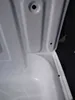 A close-up view of the interior of a white sink basin, showing the drain hole and mounting points. Náhled obrázku produktu