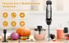 A kitchen counter with a hand blender, food processor attachment, pumpkin, onion, garlic, and a glass of smoothie. Produktbild-Vorschau