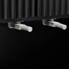 Close-up view of two magnetic door catches attached to the underside of a black ribbed surface, likely a cabinet or sideboard. Anteprima dell’immagine prodotto
