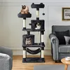 A multi-level cat tree with three cats is shown in a living room setting next to a sofa. Produktbild-Vorschau