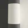A close-up view of a roll of wallpaper with a black and white striped pattern. Produktbild-Vorschau