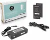 A product shot of a laptop AC adapter and its accessories, including the box, warranty cards, and cables, arranged on a white background. Produktbild-Vorschau