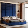 A blue upholstered bed with pillows and a throw blanket, set against a navy blue padded headboard. Anteprima dell’immagine prodotto