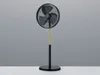 A black stand fan with a wooden accent on a plain gray background. Voir les images du produit