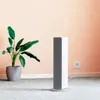 A white and gray Xiaomi Smartmi Fan Heater is placed on a light gray carpet next to a potted plant with large green leaves. Voir les images du produit