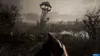 A desolate, swampy landscape with a dilapidated tower in the background, viewed from a first-person perspective holding a weapon. Produktbild-Vorschau