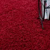 A close-up view of a red shaggy carpet. Produktbild-Vorschau