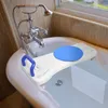 A bath seat is placed across a bathtub filled with water, with a faucet and showerhead visible. Náhľad obrázku produktu