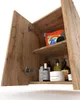An open bathroom cabinet with various toiletries and a box of laundry detergent on the shelves. Voir les images du produit