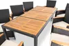 A dining set with a wooden table and black rattan chairs with beige cushions, set against a white background. Náhled obrázku produktu