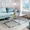 A modern living room with a teal sofa, glass coffee tables, and artwork on the wall. Produktbild-Vorschau