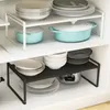 Kitchen shelves with various dishes and cookware organized on them. Voir les images du produit