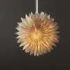 A lit paper star lantern hangs against a dark background. Podgląd zdjęcia produktu