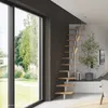 A modern interior with a spiral staircase and large windows overlooking a garden. Produktbild-Vorschau