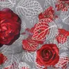 A close-up of a fabric pattern with red roses and stylized leaves on a gray background. Produktbild-Vorschau