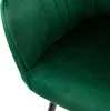 A close-up view of a green velvet chair. Náhled obrázku produktu