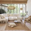 A bright and airy living room with a large sectional sofa, coffee table, and natural light streaming in from large windows. Podgląd zdjęcia produktu