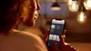 A person is holding a smartphone and controlling smart lights in a room. Produktbild-Vorschau