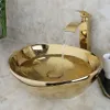 A gold basin sink with water flowing from a gold faucet. Anteprima dell’immagine prodotto