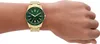 A close-up shot of a person's wrist wearing a gold Armani Exchange watch with a green dial. Anteprima dell’immagine prodotto